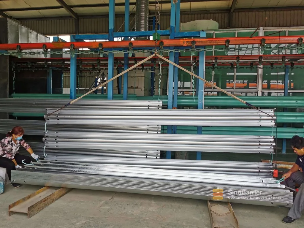 W-beam guardrail run on a highway shoulder, hot-dip galvanized to AASHTO M180